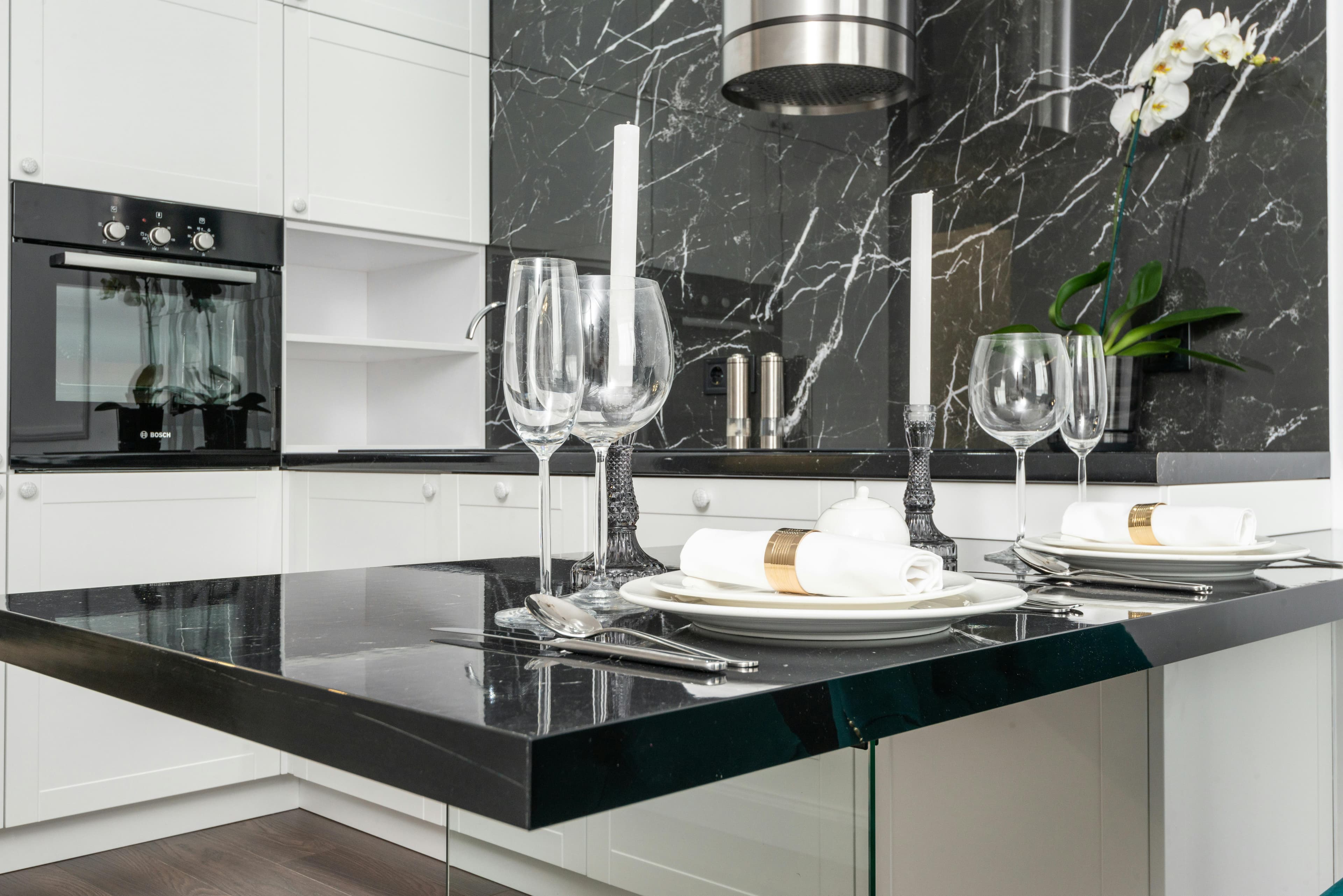 Elegant black and white marble backsplash with glossy black countertop