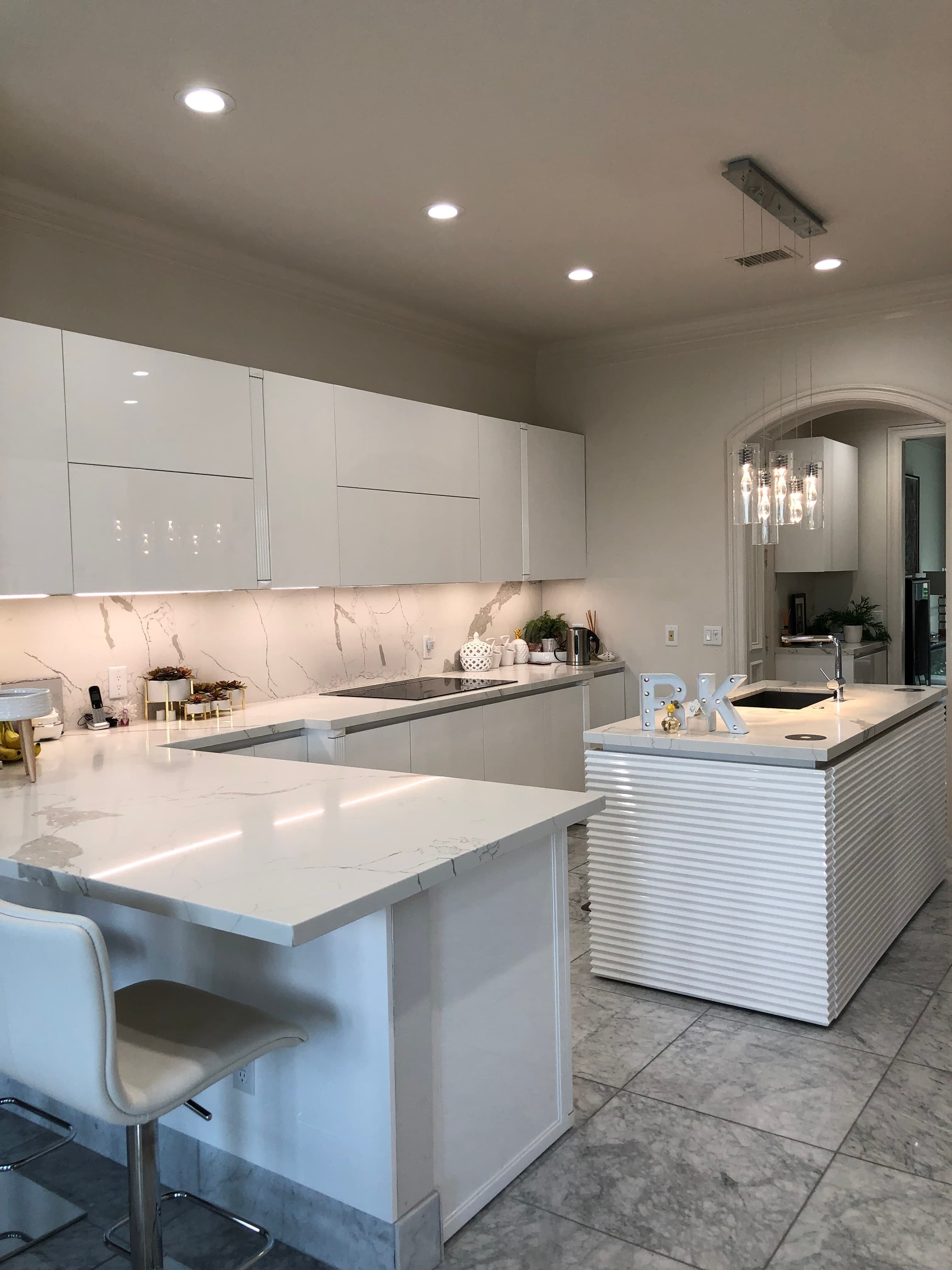Bright white quartz countertops with matching backsplash